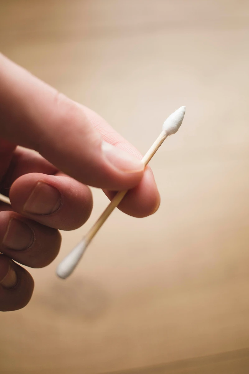 person holding a cotton swab