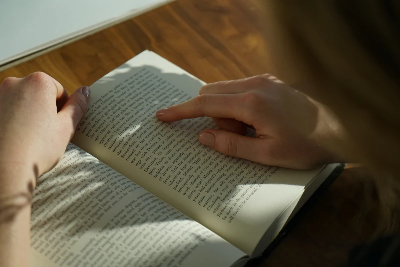 person reading with finger following