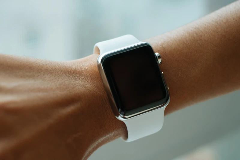 person with a square smart watch on hand