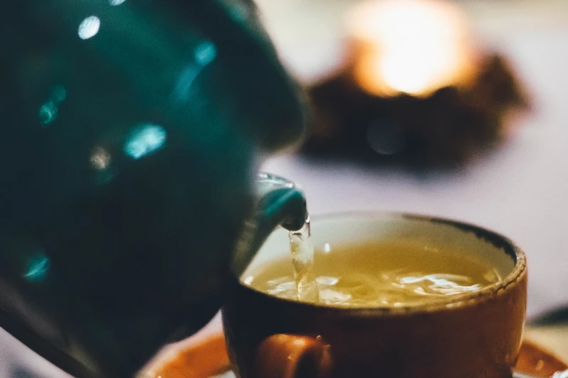 pouring green tea in a cup