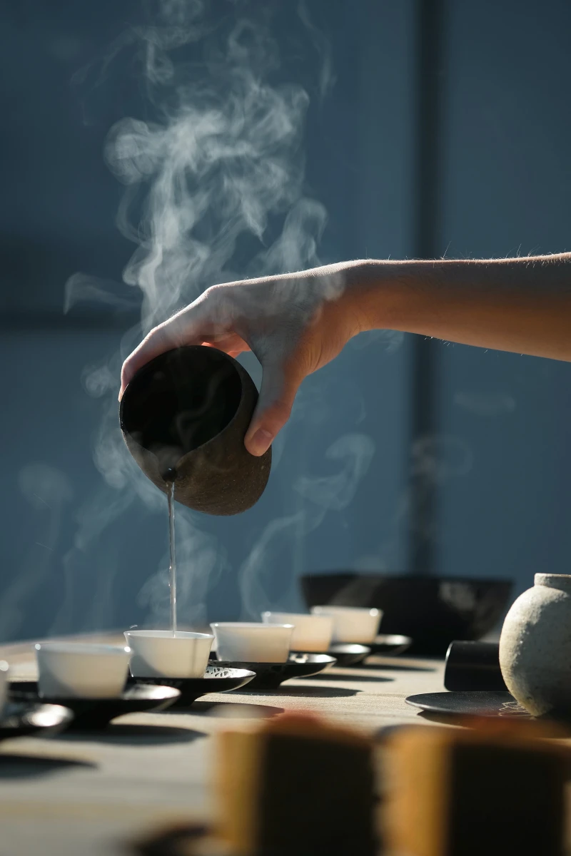 teas for a strong immune system person pouring tea in cups