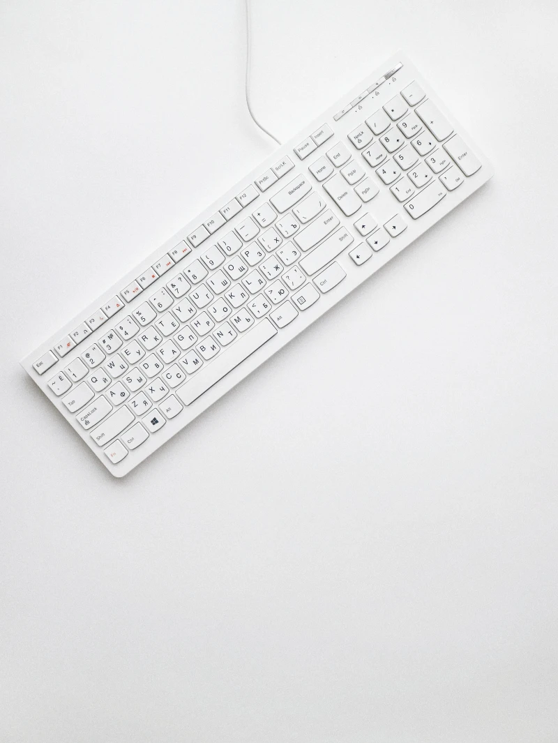 white keyboard with wire on white background
