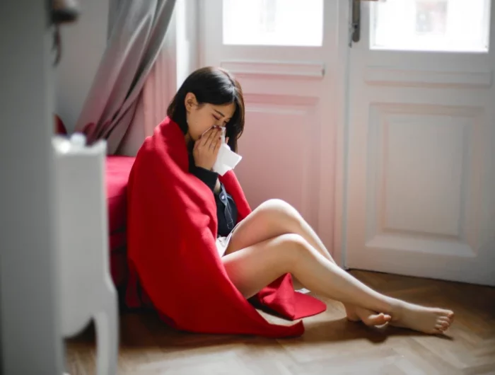 woman wrapped in a blanket on the floor