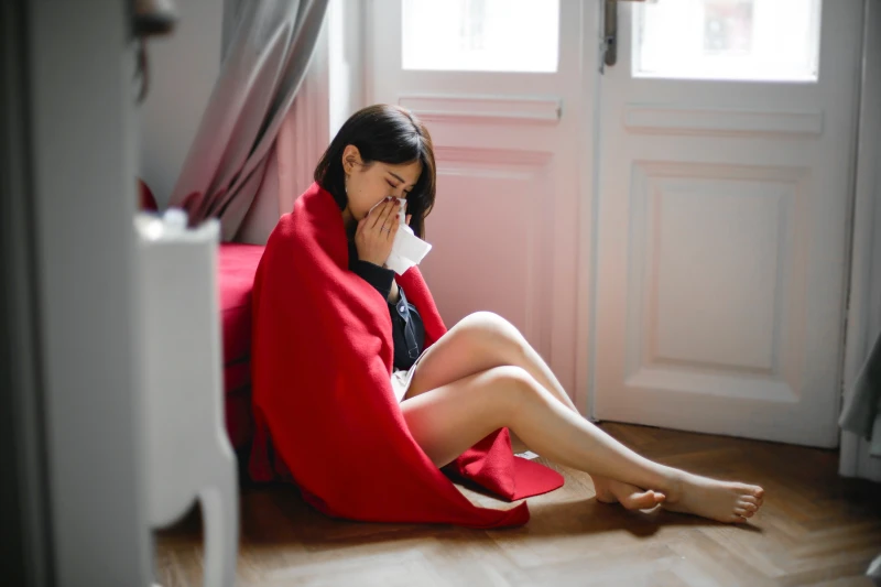 woman wrapped in a blanket on the floor