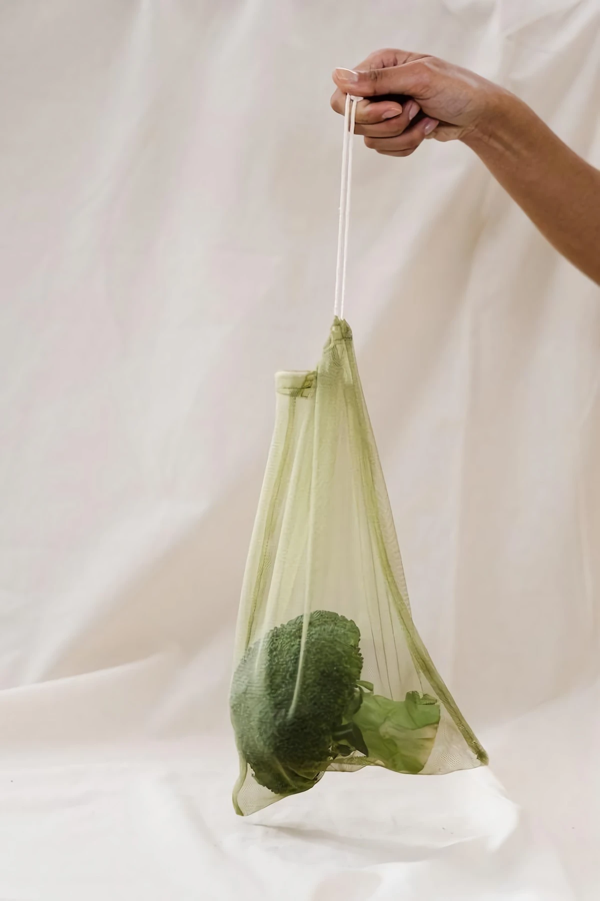 a broccoli in a mesh bag