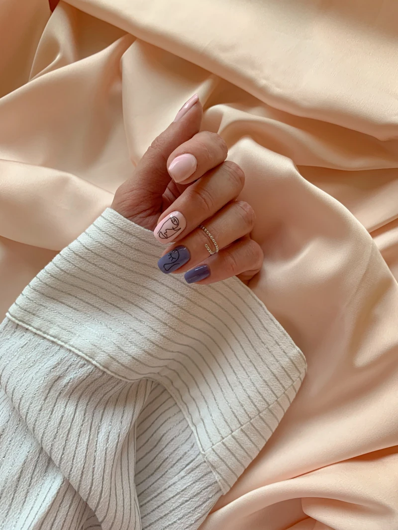 blue and beige nails with face