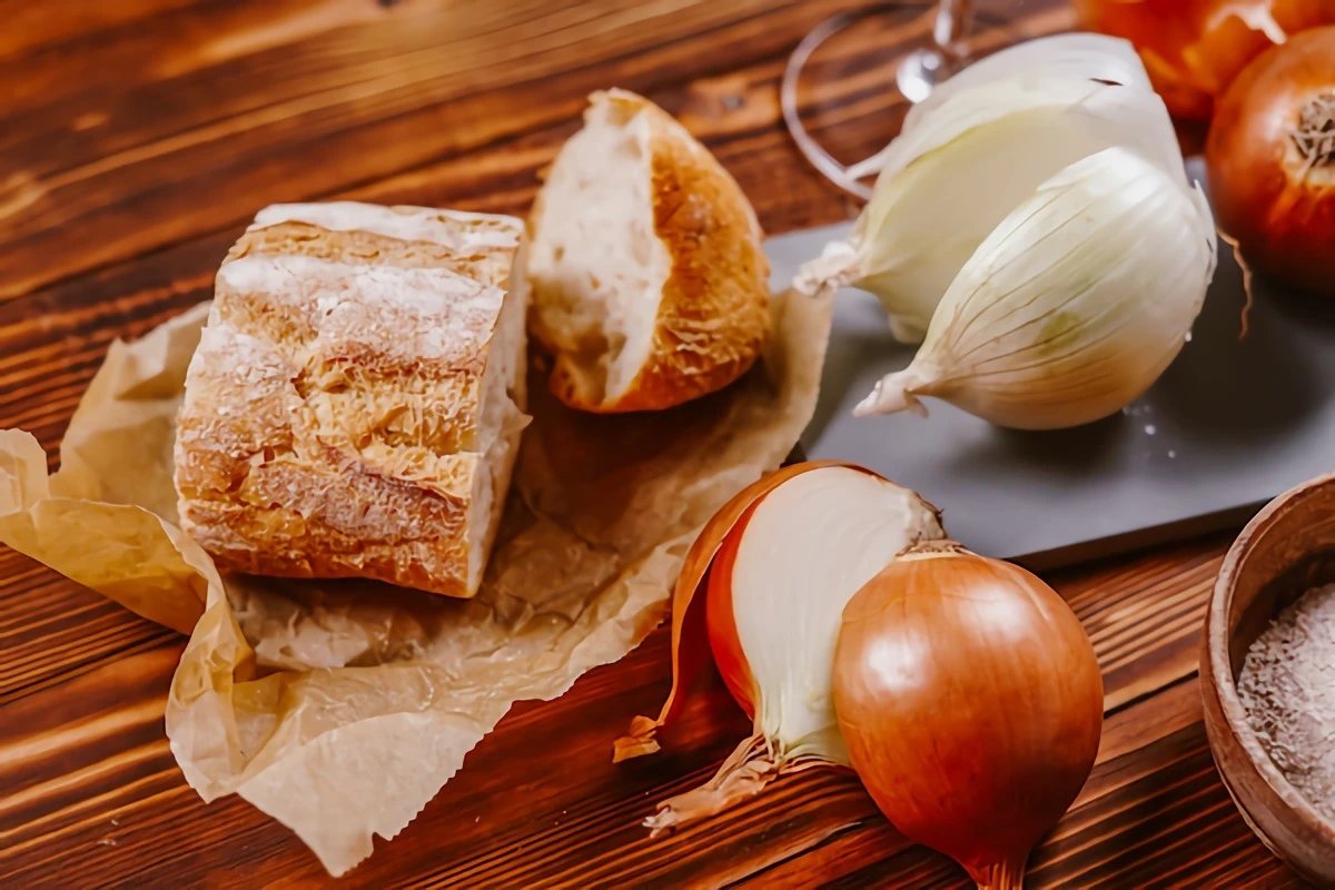 bread and onions on cutting board