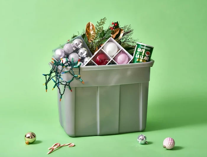 christmas decorations in container on green background
