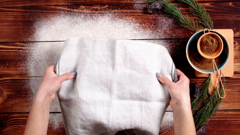 covering dough with a tea towel
