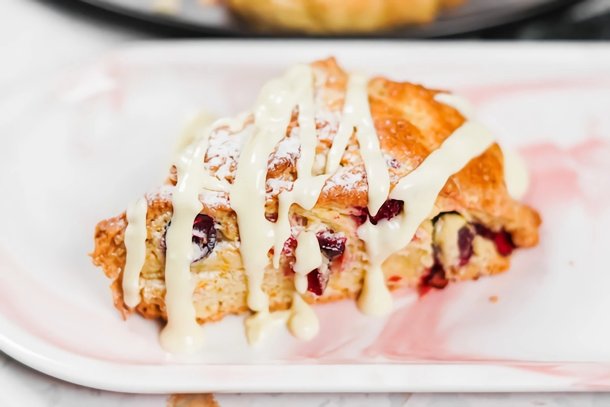 cranberry orange scones with melted drizzled white chocolate