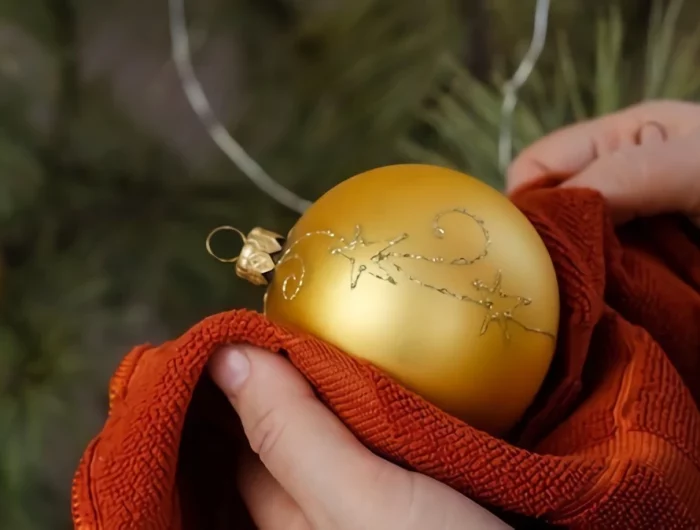 how to clean christmas ornaments person cleaning with cloth an ornament