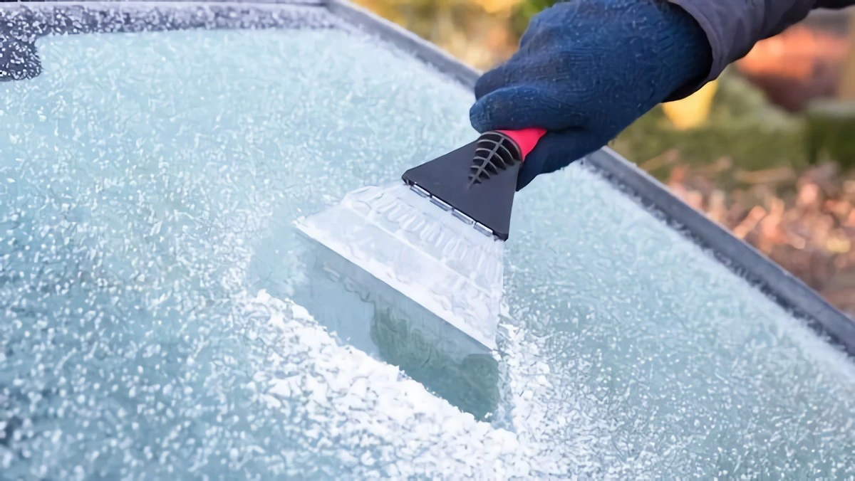 how to defrost car windows person scraping off frost from window