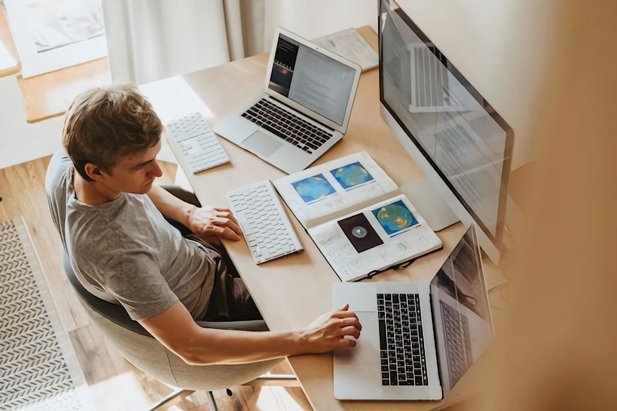 man with multiple devices in front of him