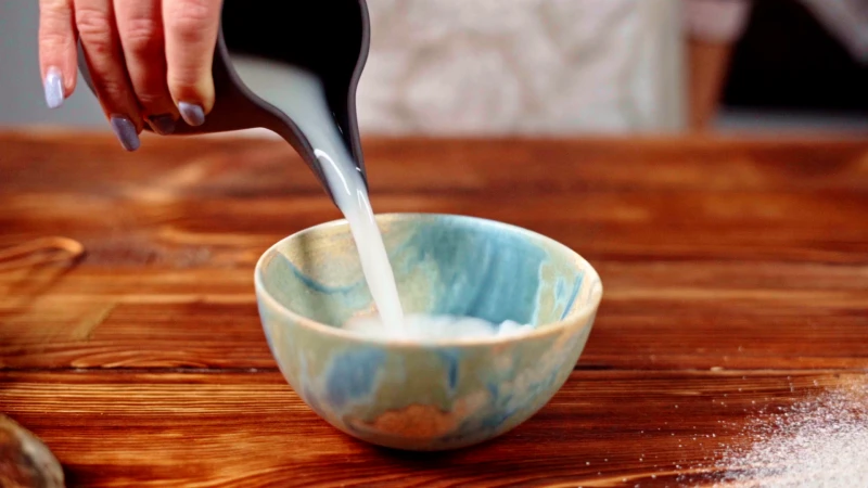 pouring coconut milk in bowl