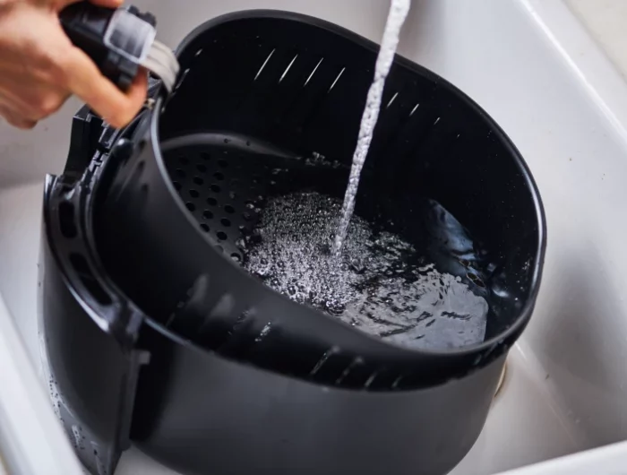 washing air fryer in the sink