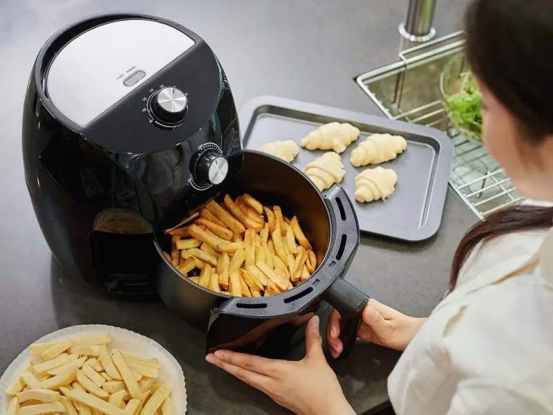 woman cooking with air fryer