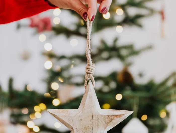 woman holding a star ornament