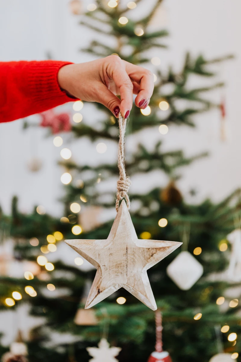 woman holding a star ornament