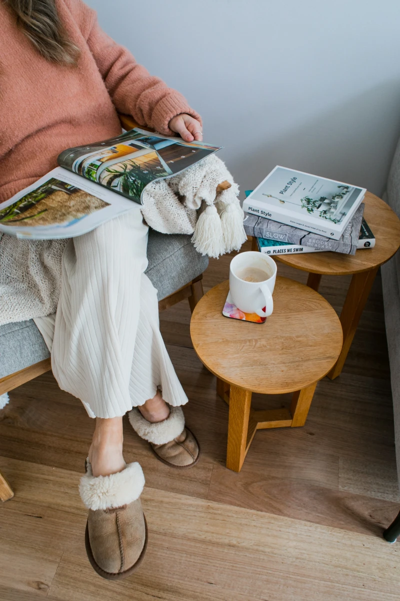 woman reading with cozy slippers
