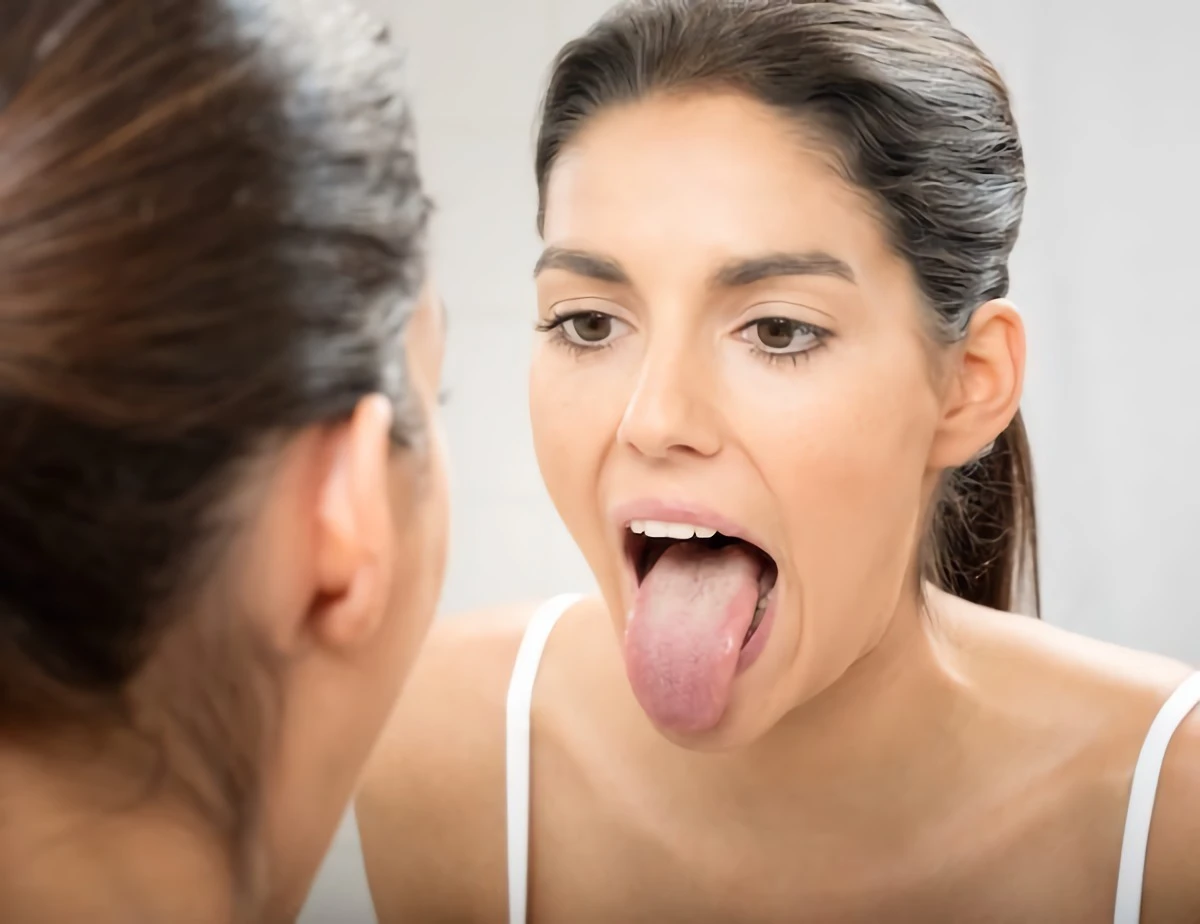 woman sticking out her tongue in mirror