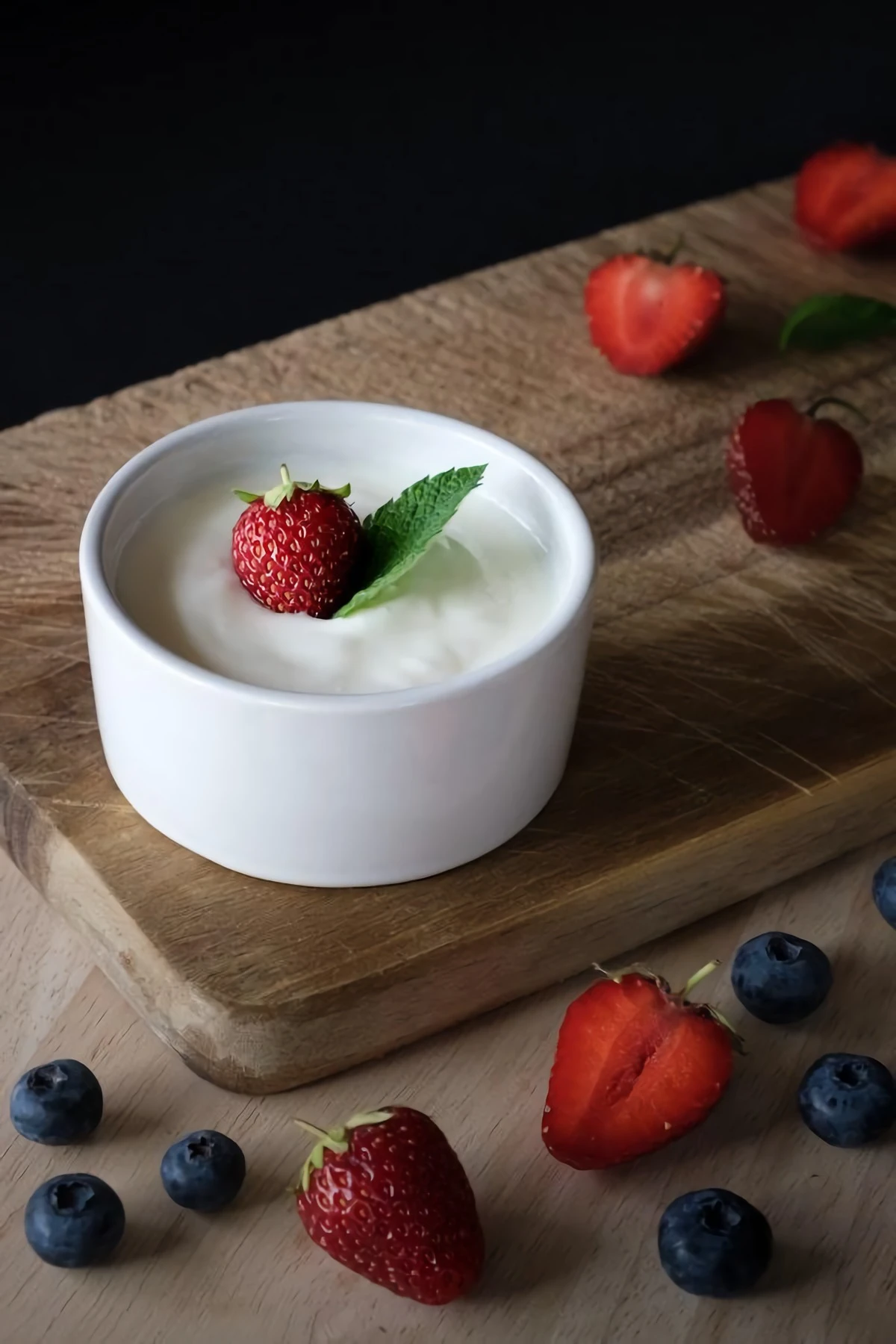 yogurt in a white bowl with berries