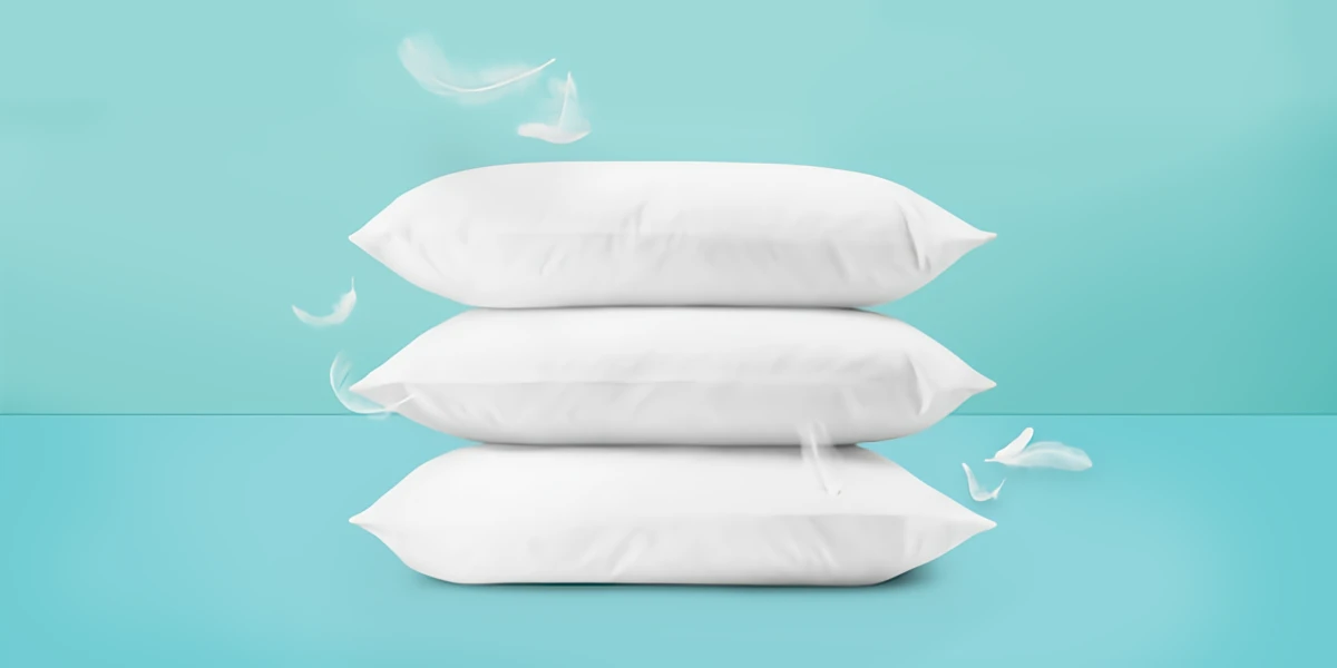 down and feather pillows on blue background
