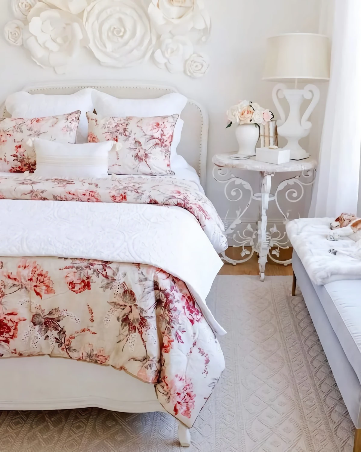 floral bed linens on bed with white heaboard