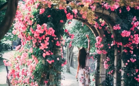 full lush arch with pink flowers