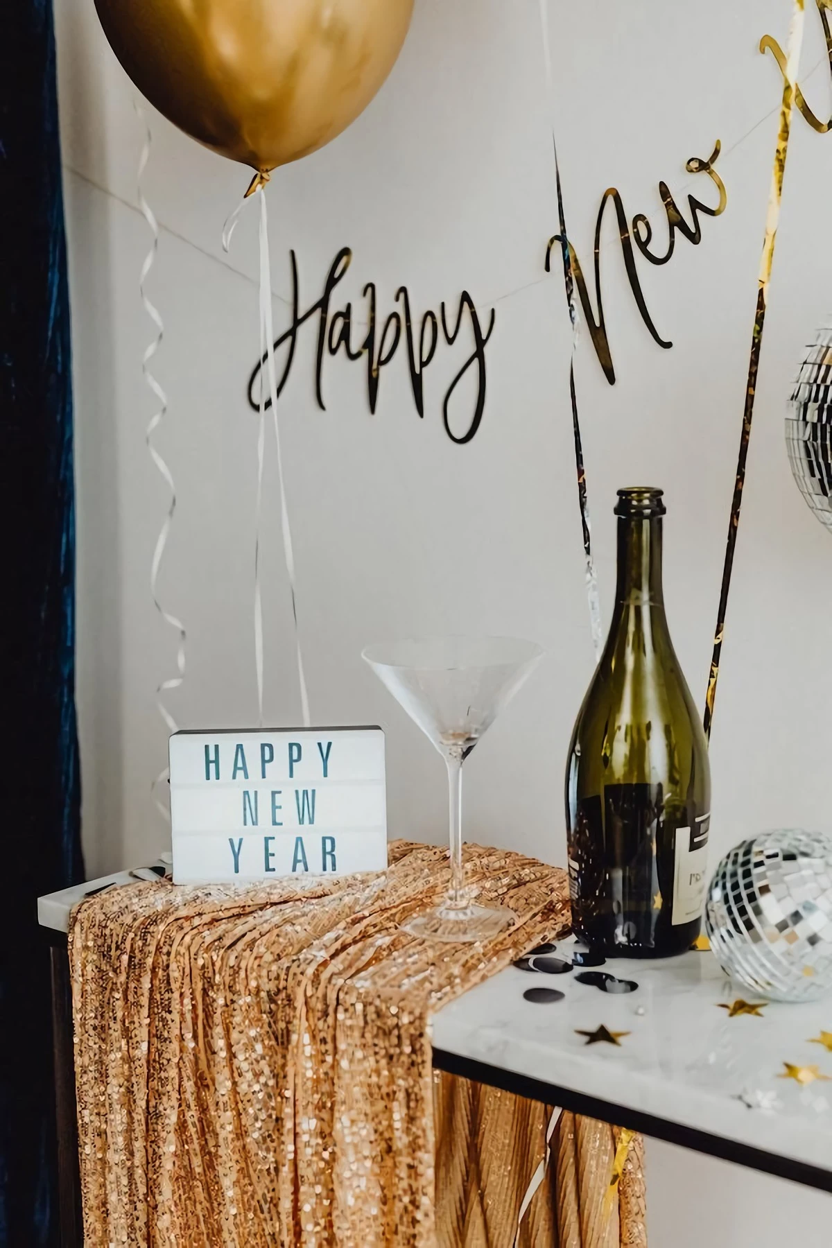 happy new year sign with martini glass and champangne