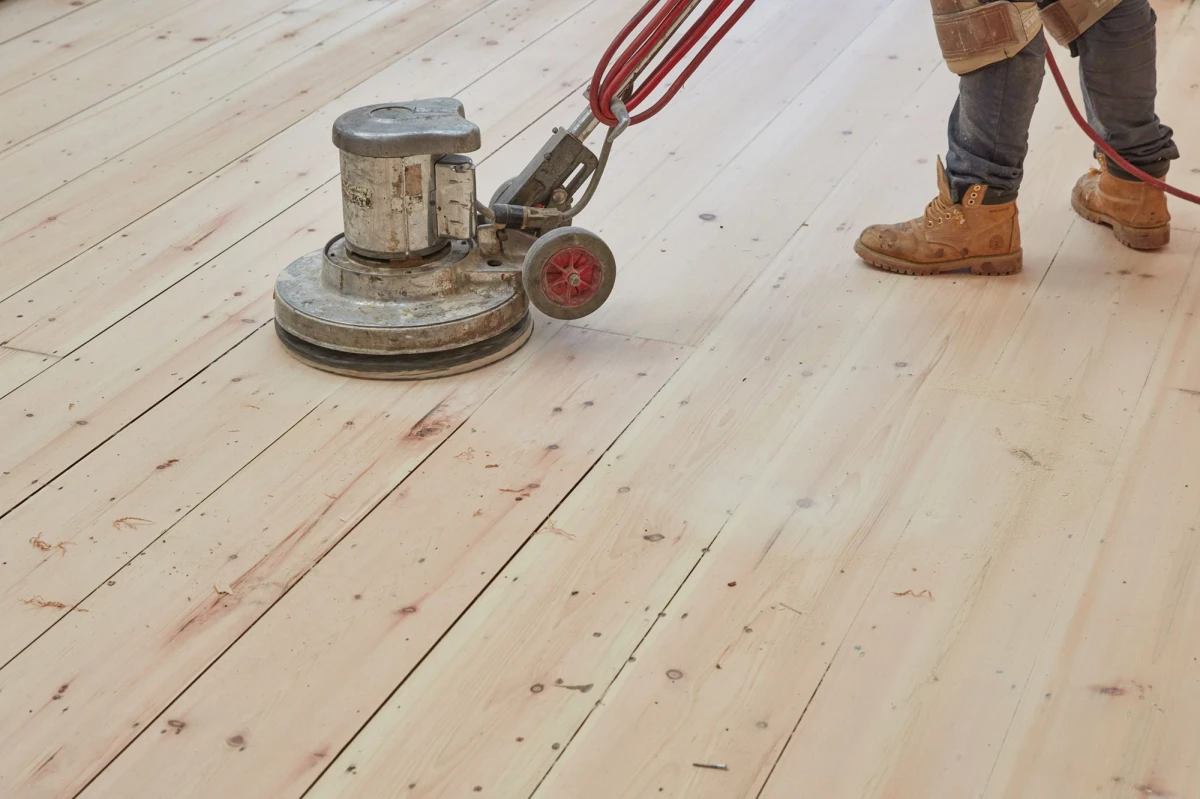 hardwood floor scratch repair person sanding a wooden floor