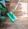 how to clean hardwood floors person moping the floors