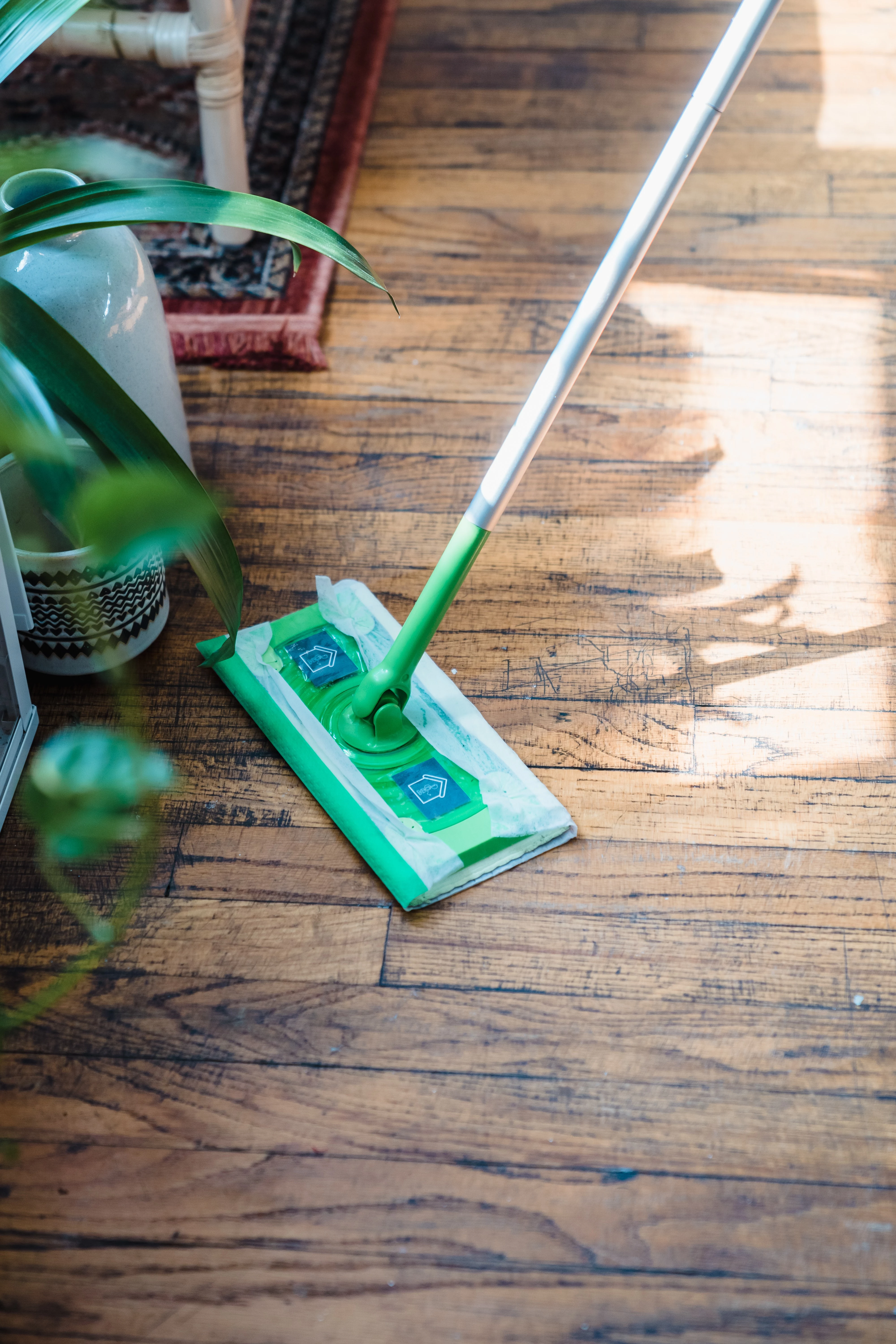 how to clean hardwood floors person moping the floors