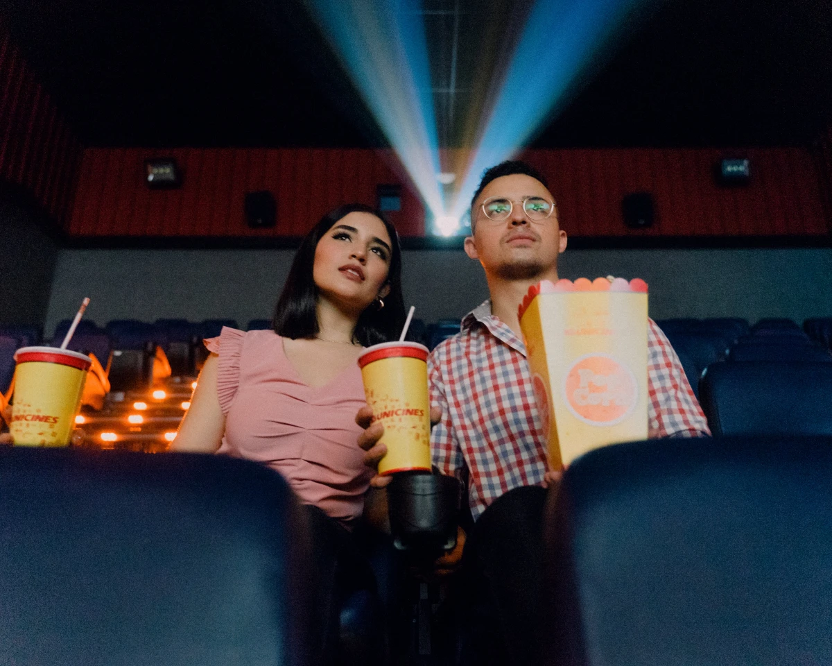 man and woman watching a movie together