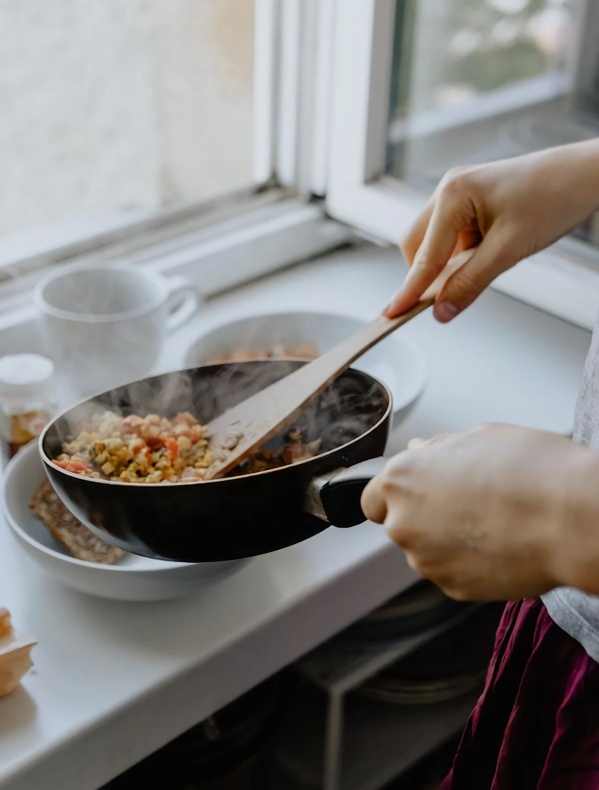 person cooking in a pan