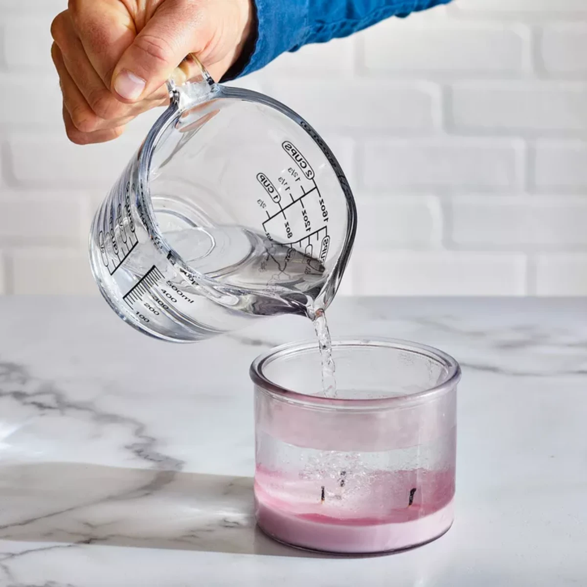 pouring boiling water in candle jar