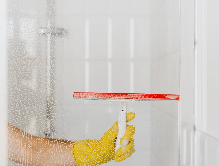 squeegee cleaning shower glass door