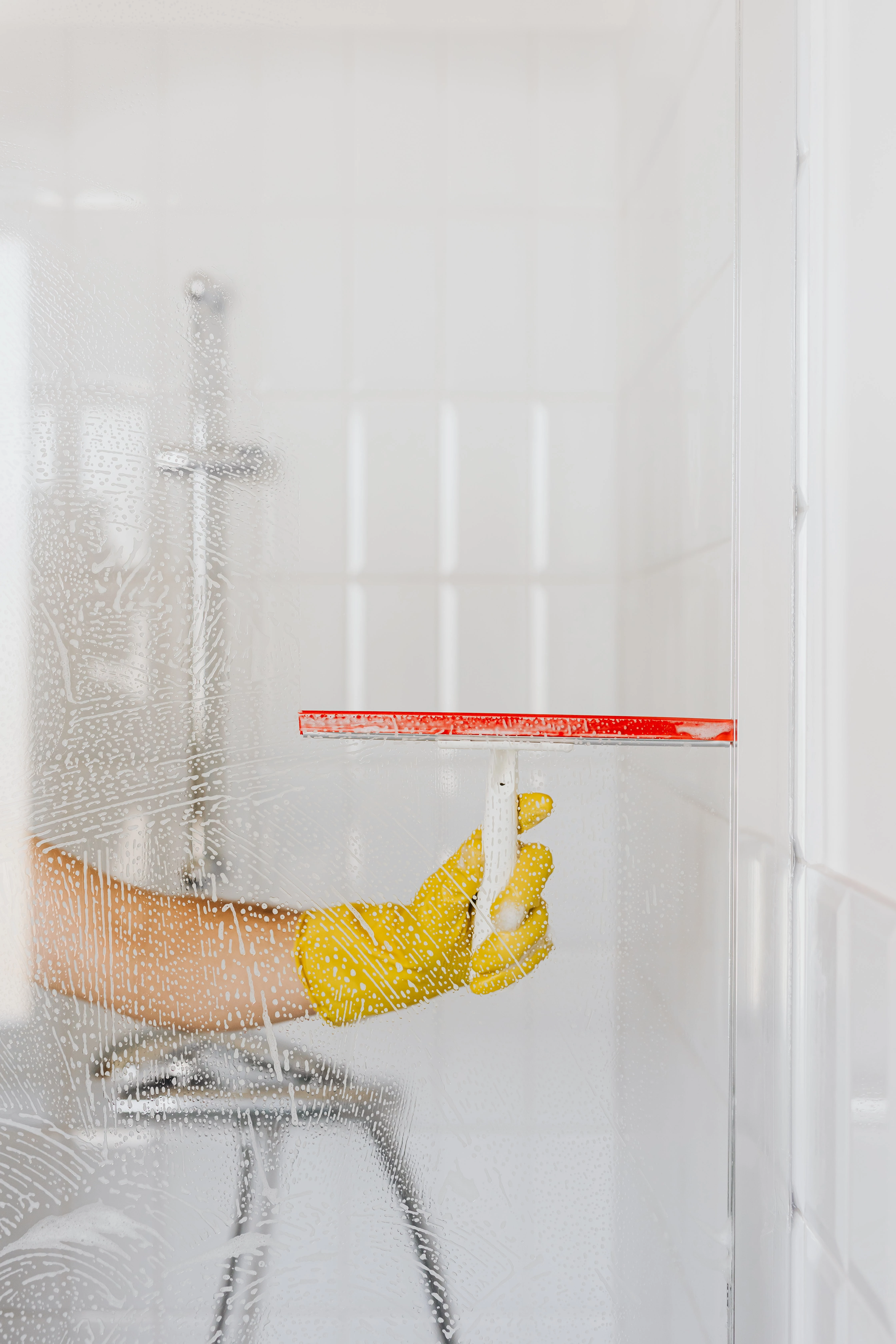 squeegee cleaning shower glass door