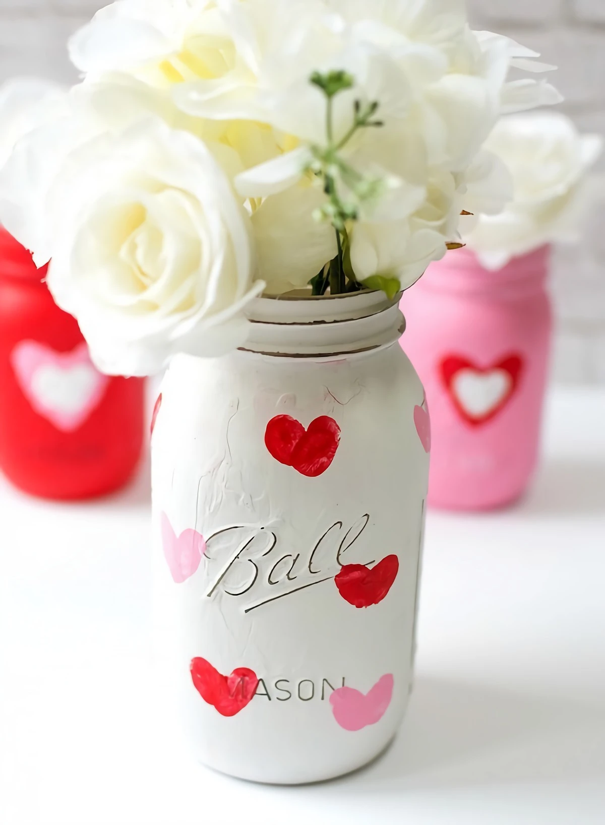 white painted mason jar with finger print hearts