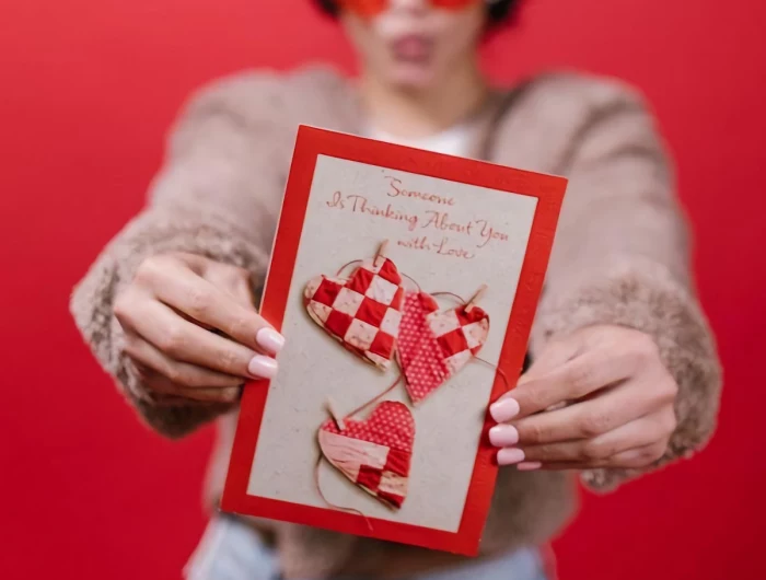 woman holding a valentines day card