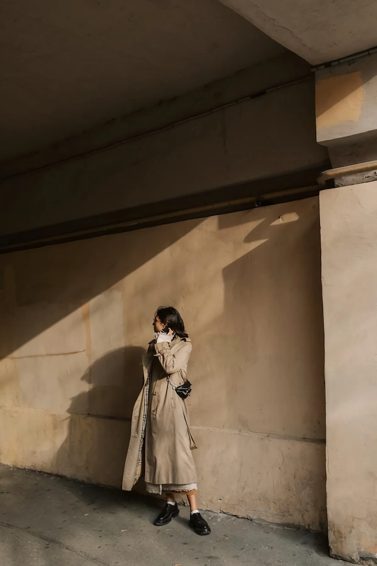 woman in a beige trench coat