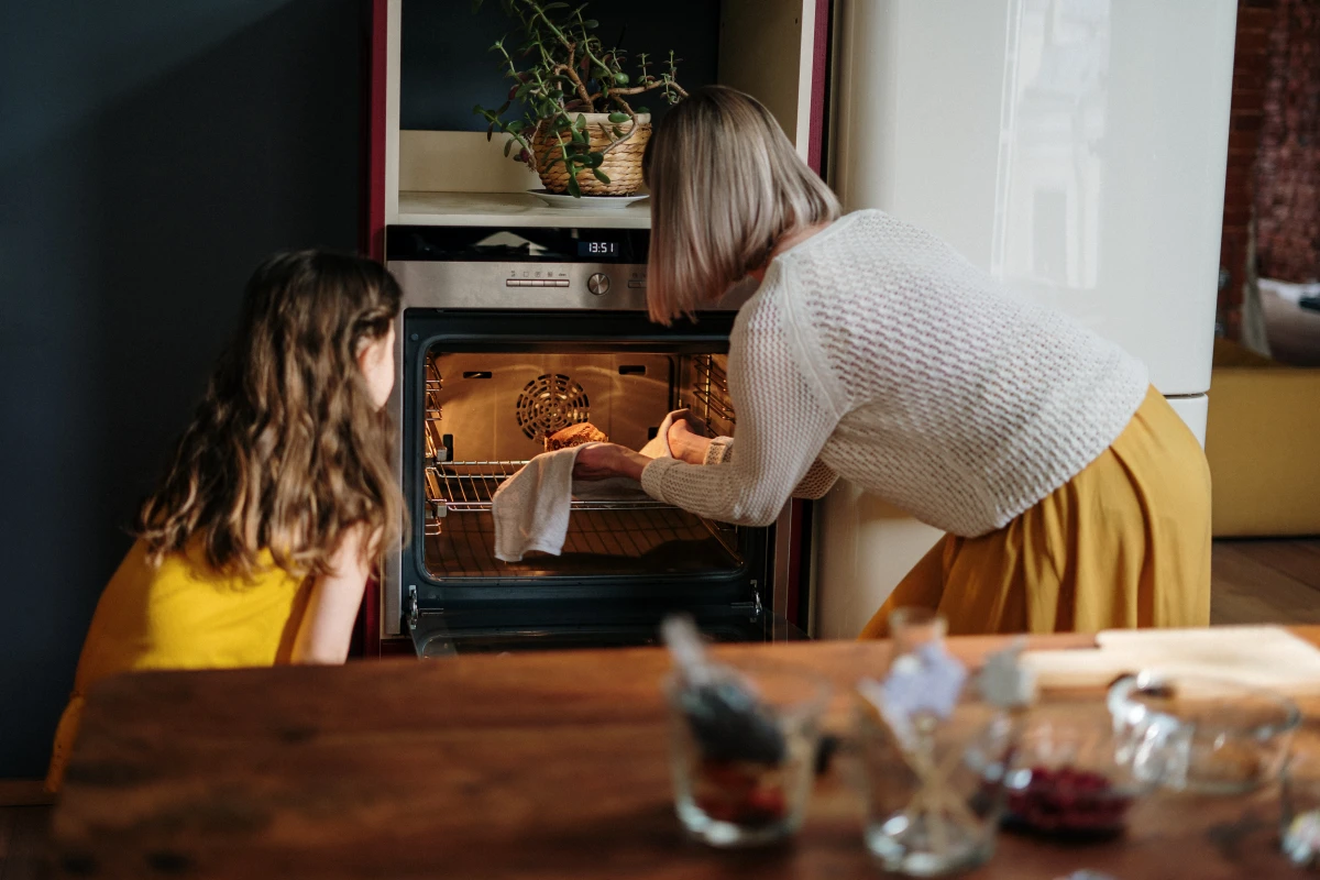woman putting something in the oven