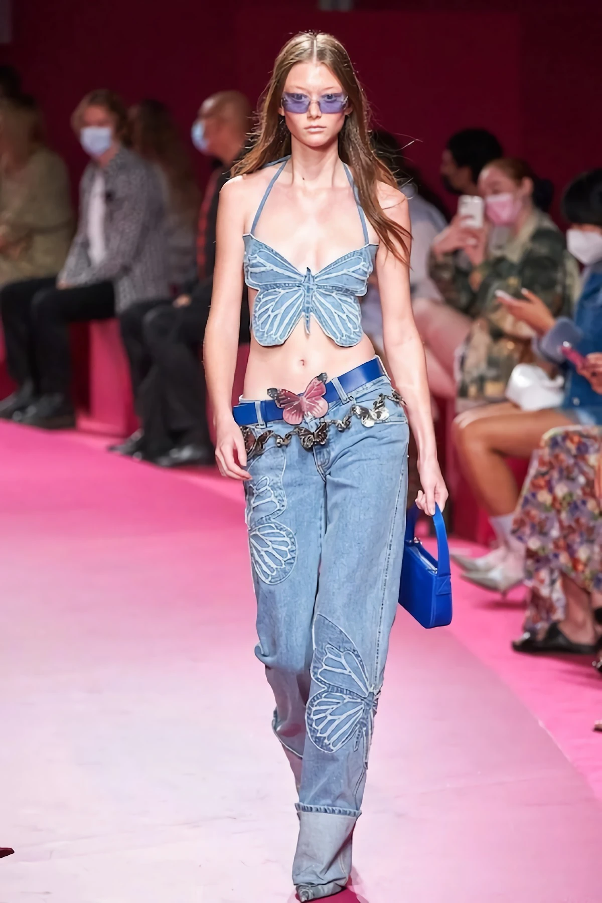 woman wearing low rise jeans and denim butterfly top