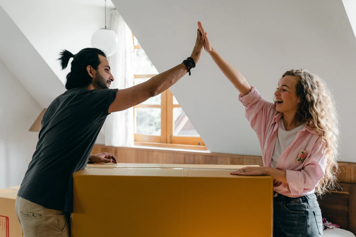 man and woman high fiving