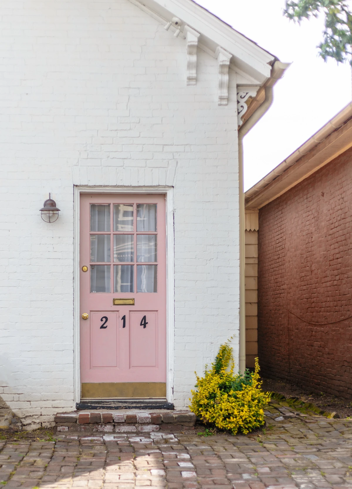pink door on white home