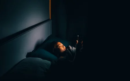woman on phone in bed