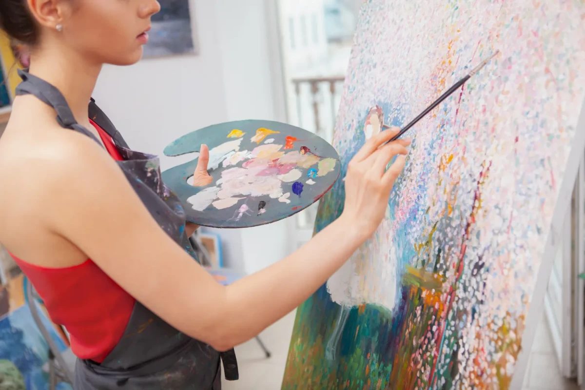 woman painting on canvas