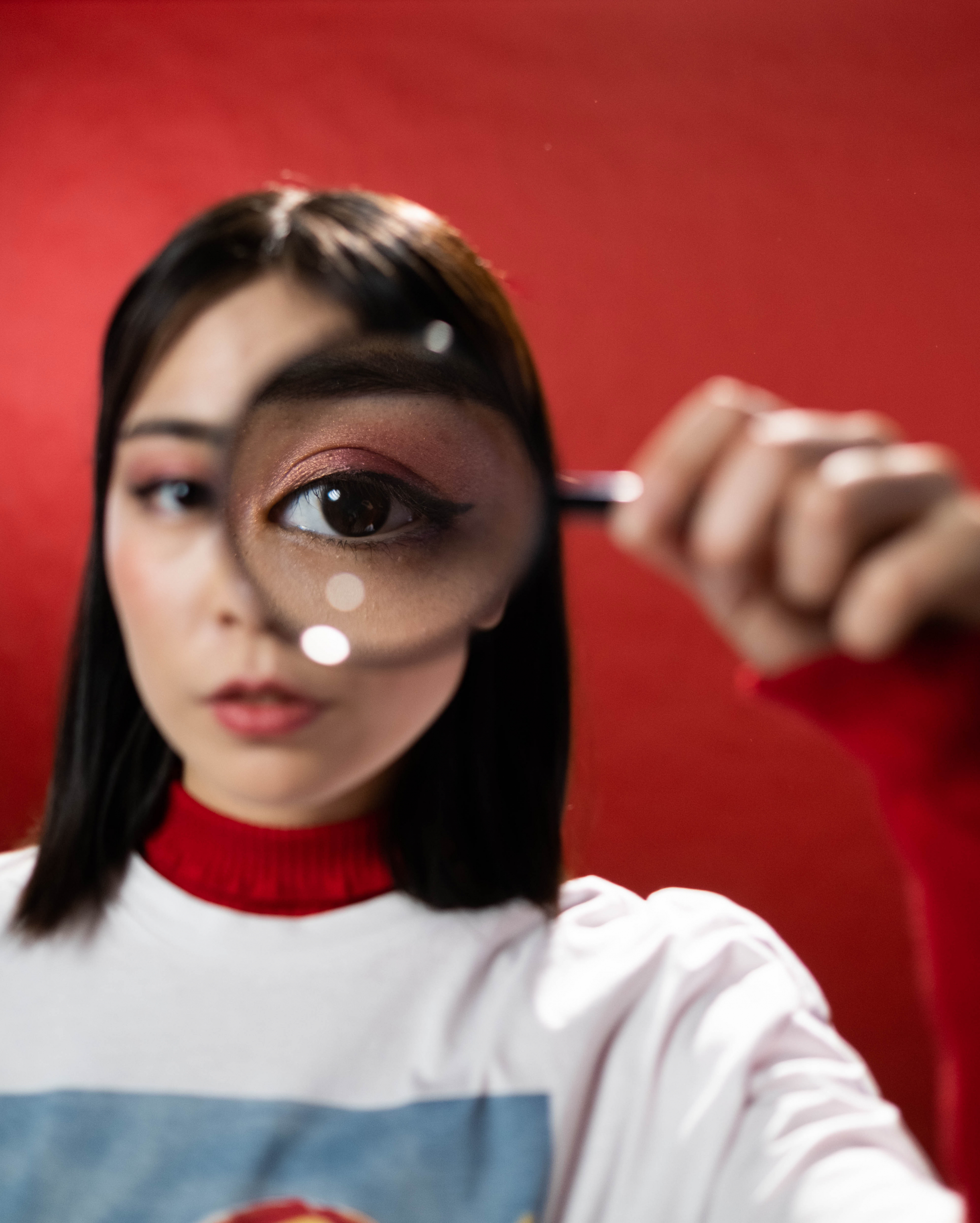 woman with magnifiying glass in front of eye