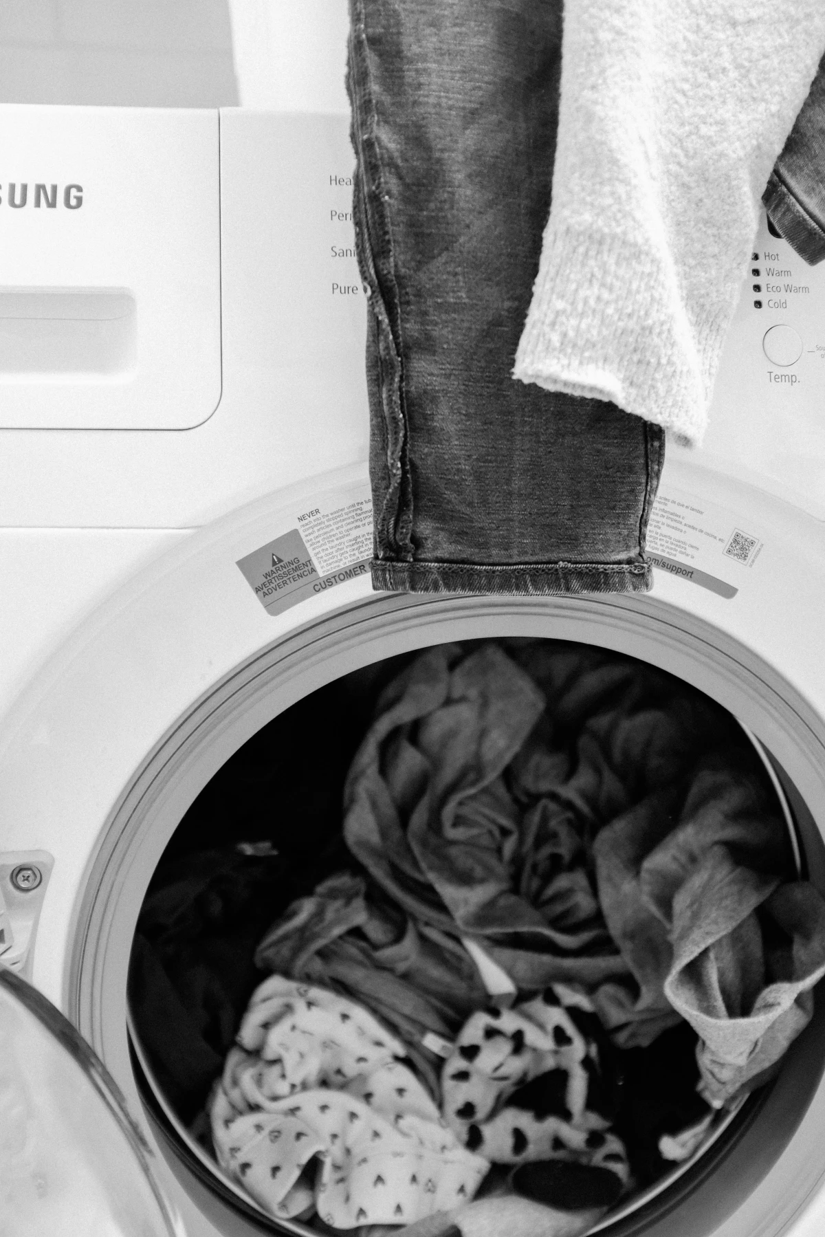 clothes in dryer in black and white