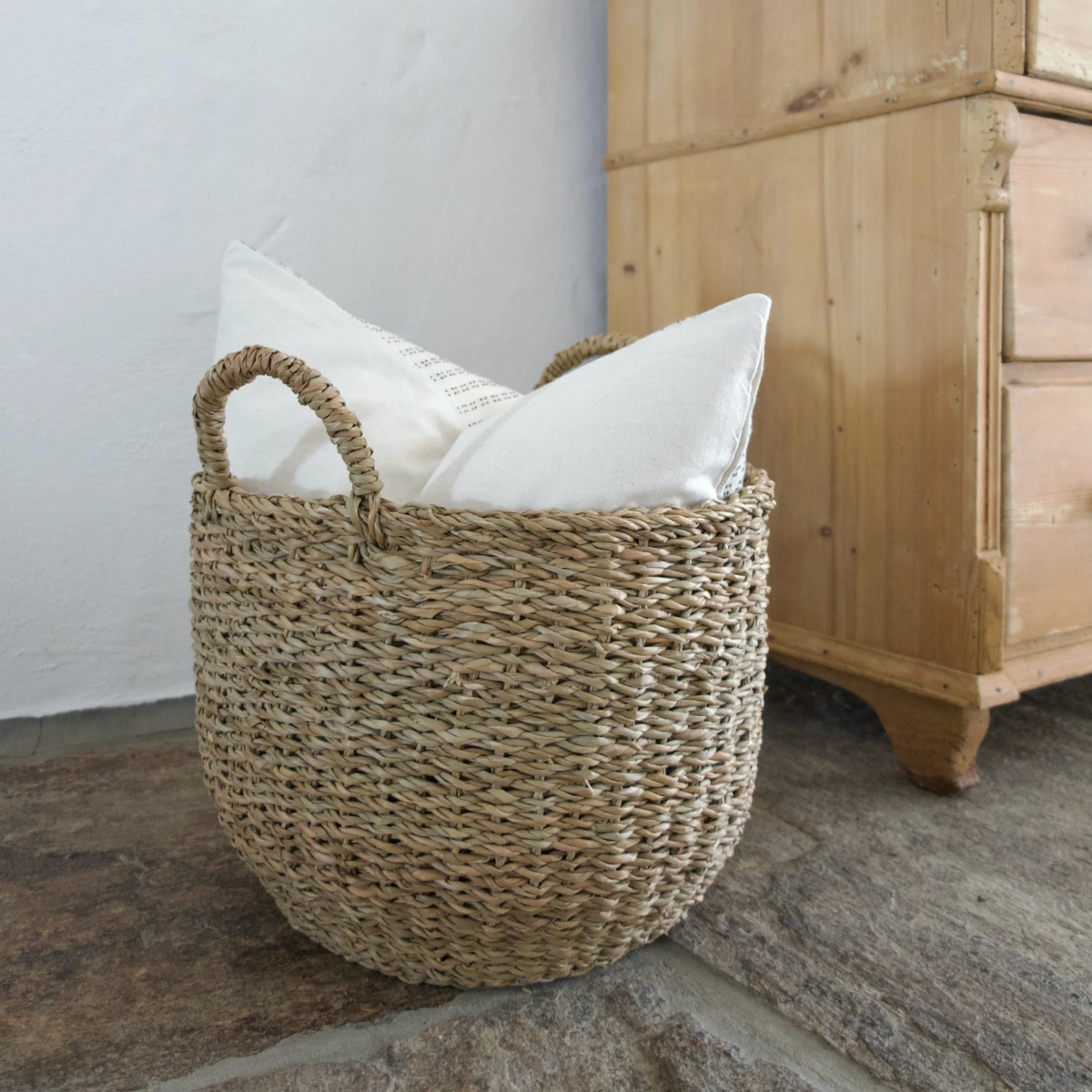 how to organize a nightstand woven basket with pillow inside