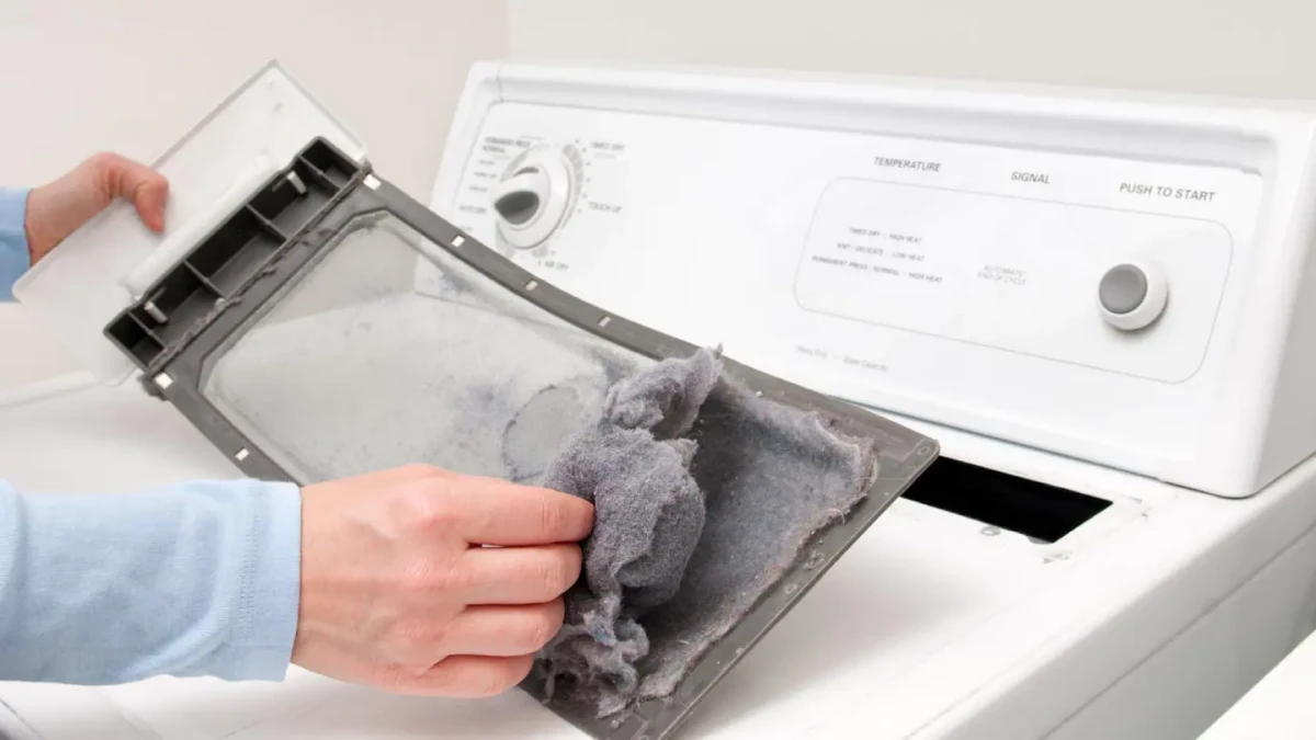man cleaning lint trap